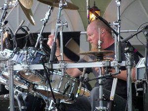 Gary Moffatt playing his drum kit on an outdoor stage