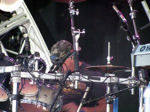 Gary Moffatt seated behind the drums and cymbals