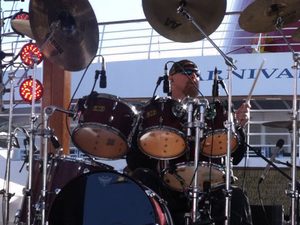 Gary Moffatt playing drums at an outdoor concert